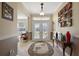 Elegant foyer with tile flooring, a decorative rug, and glass double doors leading to the outside at 12133 Se 91St Ter, Summerfield, FL 34491