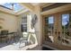 Inviting covered front porch featuring a seating area and decorative glass double front doors at 12133 Se 91St Ter, Summerfield, FL 34491