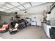Spacious three car garage featuring plenty of storage space and a workbench area at 12133 Se 91St Ter, Summerfield, FL 34491