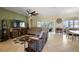 Spacious living room with tile flooring, a ceiling fan, and a sliding glass door to the outdoor living space at 12133 Se 91St Ter, Summerfield, FL 34491