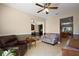 Relaxing living room featuring neutral paint colors, tile flooring, and a ceiling fan at 12133 Se 91St Ter, Summerfield, FL 34491
