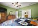 Spacious main bedroom with wood flooring, a dresser, and an ensuite bathroom at 12133 Se 91St Ter, Summerfield, FL 34491