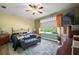 Bright bedroom with a ceiling fan, large windows, and carpeted floors at 12133 Se 91St Ter, Summerfield, FL 34491