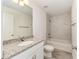 Bathroom featuring a granite vanity and a tub/shower combo with marble-look tile at 127 Sw Alvarez Rd, Dunnellon, FL 34431