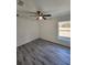 Bedroom features a large window, a ceiling fan, and wood-look vinyl floors at 127 Sw Alvarez Rd, Dunnellon, FL 34431