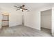 Bright bedroom with sleek gray floors, a ceiling fan, a closet, and an en-suite bathroom at 127 Sw Alvarez Rd, Dunnellon, FL 34431