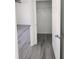 Open closet revealing hanging rod and light gray laminate flooring extending from the adjacent bedroom at 127 Sw Alvarez Rd, Dunnellon, FL 34431