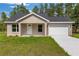 Charming single-story home features a fresh lawn, an attached garage, and a neutral stucco exterior at 127 Sw Alvarez Rd, Dunnellon, FL 34431