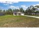 A single-story home set on a sprawling lawn next to a long driveway and detached building at 127 Sw Alvarez Rd, Dunnellon, FL 34431