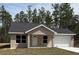 Charming single-story home boasts a well-maintained lawn, a concrete driveway, and a neutral-colored stucco exterior at 127 Sw Alvarez Rd, Dunnellon, FL 34431