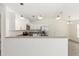 White kitchen with stainless appliances, granite countertops, and a breakfast bar open to the living room at 127 Sw Alvarez Rd, Dunnellon, FL 34431