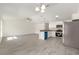 Bright kitchen features stainless appliances, white cabinets and an island with an open view to the living area at 127 Sw Alvarez Rd, Dunnellon, FL 34431