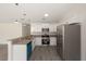 A bright, modern kitchen with stainless steel appliances, granite countertops, and sleek gray flooring at 127 Sw Alvarez Rd, Dunnellon, FL 34431