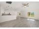 Bright and open living area with gray flooring, connecting seamlessly to the kitchen area at 127 Sw Alvarez Rd, Dunnellon, FL 34431