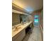 Double vanity bathroom with lots of counter space and access to the pool area at 19726 Sw 95Th St, Dunnellon, FL 34432