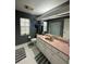 Bathroom featuring modern fixtures, including a white sink, toilet, and a large mirror at 19726 Sw 95Th St, Dunnellon, FL 34432