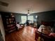 Cozy bedroom with hardwood floors, a ceiling fan, and natural light at 19726 Sw 95Th St, Dunnellon, FL 34432