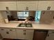 Bright kitchen with stainless steel sink and view of the dining room at 19726 Sw 95Th St, Dunnellon, FL 34432