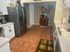 Eat-in kitchen with stainless steel refrigerator and adjacent dining area at 19726 Sw 95Th St, Dunnellon, FL 34432