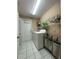 Bright laundry room with modern washer and dryer, storage shelves, and a folding area at 19726 Sw 95Th St, Dunnellon, FL 34432