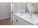 Bathroom featuring a double sink vanity with sleek faucets and a walk-in closet at 3085 Sw 131St Place Rd, Ocala, FL 34473