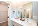 Bright bathroom features double vanity with modern fixtures, framed mirrors, and walk-in closet at 3085 Sw 131St Place Rd, Ocala, FL 34473