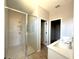 Modern bathroom featuring a glass-enclosed shower, double sink vanity, and neutral color scheme at 3085 Sw 131St Place Rd, Ocala, FL 34473