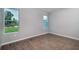 Bright bedroom featuring tile floors and a view of the backyard through two windows at 3085 Sw 131St Place Rd, Ocala, FL 34473