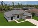 Aerial view of a single-Gathering home with a manicured lawn and gray shingle roof at 3085 Sw 131St Place Rd, Ocala, FL 34473