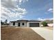 Single Gathering home showcasing stone detail, grey siding, and covered two car garage at 3085 Sw 131St Place Rd, Ocala, FL 34473