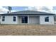 Exterior back view of home with covered porch and yard at 3085 Sw 131St Place Rd, Ocala, FL 34473