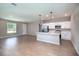 Open-concept kitchen area with stainless steel appliances, bright white cabinets, and ceramic tile floors at 3085 Sw 131St Place Rd, Ocala, FL 34473