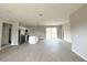 Expansive living area with abundant light, sleek island kitchen, and access to the backyard at 3085 Sw 131St Place Rd, Ocala, FL 34473