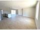 Open-concept living area with modern tile floors seamlessly connected to the kitchen and dining spaces at 3085 Sw 131St Place Rd, Ocala, FL 34473