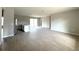 Spacious open-plan living area with tile floors, a center kitchen island, and sliding glass doors to the backyard at 3085 Sw 131St Place Rd, Ocala, FL 34473
