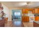 Functional kitchen with wood cabinetry, tiled floors, and access to adjacent room through sliding doors at 324 S Highland St, Bushnell, FL 33513