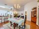 Open dining room featuring a chandelier, stylish furniture, and seamless connectivity to other living spaces at 3785 Avon Ct, Clermont, FL 34711