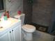 Modern bathroom with white vanity, gray walls, and shower with dark floors at 409 Marion Oaks Dr, Ocala, FL 34473