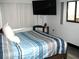 Bedroom featuring a large window, wood floors, and a flat screen television at 409 Marion Oaks Dr, Ocala, FL 34473