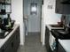Efficient galley kitchen with dark cabinets, light countertops, and modern appliances at 409 Marion Oaks Dr, Ocala, FL 34473