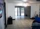 Open living room with tile flooring leading to an outdoor pool at 409 Marion Oaks Dr, Ocala, FL 34473