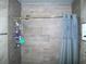 Shower stall features gray walls, a chrome shower head, and a blue shower curtain at 409 Marion Oaks Dr, Ocala, FL 34473