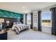 Stylish bedroom showcasing an accent wall, patterned bedding, and ample natural light from the large windows at 4258 Sw 53Rd Lane Rd, Ocala, FL 34474