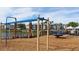 Community playground area with modern equipment, lush landscaping, and a view of nearby buildings and pond at 4258 Sw 53Rd Lane Rd, Ocala, FL 34474