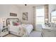 Comfortable bedroom featuring a full-sized bed, decorative artwork, and an abundance of natural light at 4266 Sw 53Rd Lane Rd, Ocala, FL 34474