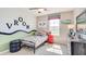 Bright bedroom decorated with car themed decor, a ceiling fan, and a window with views of the neighborhood at 4266 Sw 53Rd Lane Rd, Ocala, FL 34474