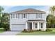 Charming two-story home showcasing a manicured lawn, neutral color palette, and an attached two car garage at 4266 Sw 53Rd Lane Rd, Ocala, FL 34474