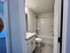 Bathroom with a single vanity, tiled floors and combined tub and shower creates a serene retreat at 4381 Sw 90Th Pl, Ocala, FL 34476