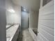Bright bathroom featuring double vanity, granite countertop, and separate bathtub and shower at 4381 Sw 90Th Pl, Ocala, FL 34476