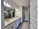 Bright bathroom featuring a double vanity with granite countertops and tiled floors and glass shower at 4381 Sw 90Th Pl, Ocala, FL 34476